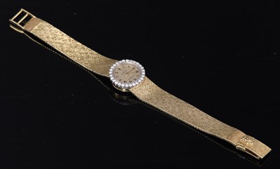 Lot 179 - A ladies' 18ct gold diamond set mechanical bracelet watch