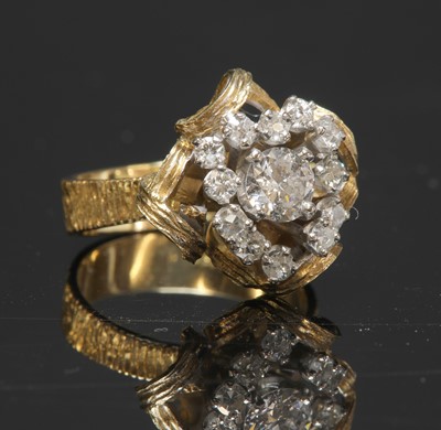Lot 161 - A two colour gold diamond set cluster ring, c.1970