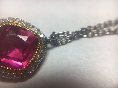 Lot 19 - A platinum pink tourmaline and diamond halo cluster pendant