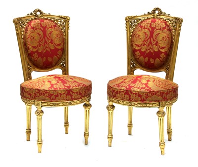 Lot 692 - A pair of French Louis XVI-style giltwood salon chairs