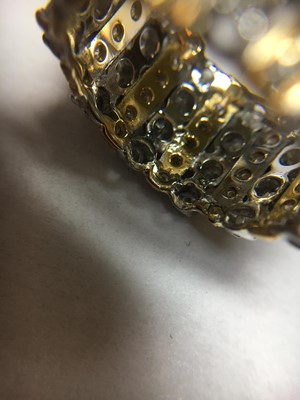 Lot 76 - A two colour gold diamond set band ring