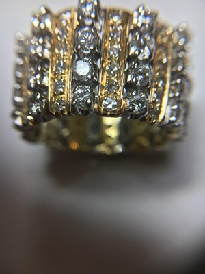 Lot 76 - A two colour gold diamond set band ring