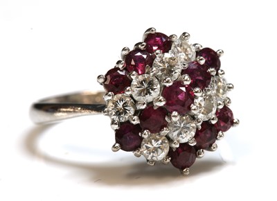 Lot 243 - A white gold ruby and diamond hexagonal cluster ring