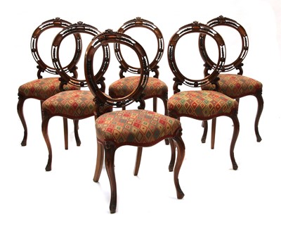 Lot 624 - A set of six walnut hoop back chairs