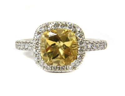 Lot 153 - A platinum citrine and diamond halo cluster ring