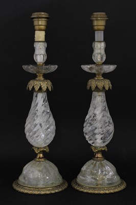 Lot 523 - A pair of rock crystal and bronze candlesticks