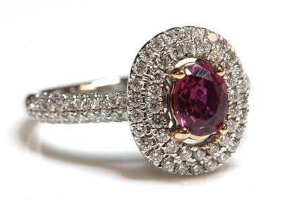 Lot 67 - An 18ct rose and white gold, ruby and diamond, two row halo cluster ring