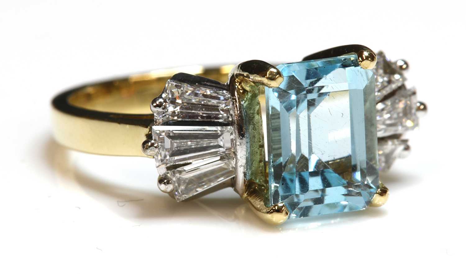 Lot 257 - An 18ct gold blue topaz and diamond ring
