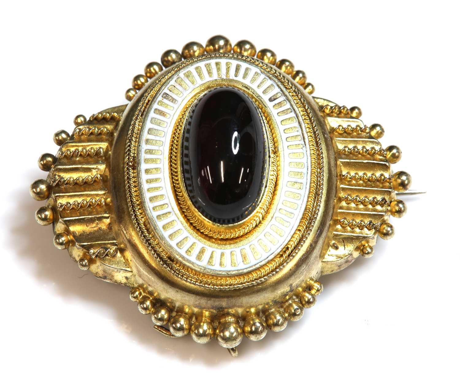 Lot 4 - A Victorian Etruscan Revival gold garnet and enamel shield form brooch, c.1860