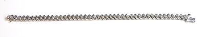 Lot 275 - A white gold diamond set line bracelet