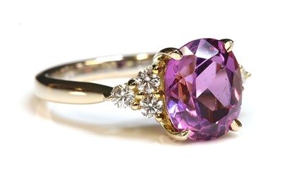 Lot 261 - An 18ct gold synthetic sapphire and diamond ring
