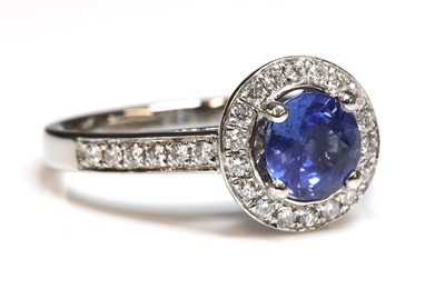 Lot 231 - A platinum sapphire and diamond halo cluster ring