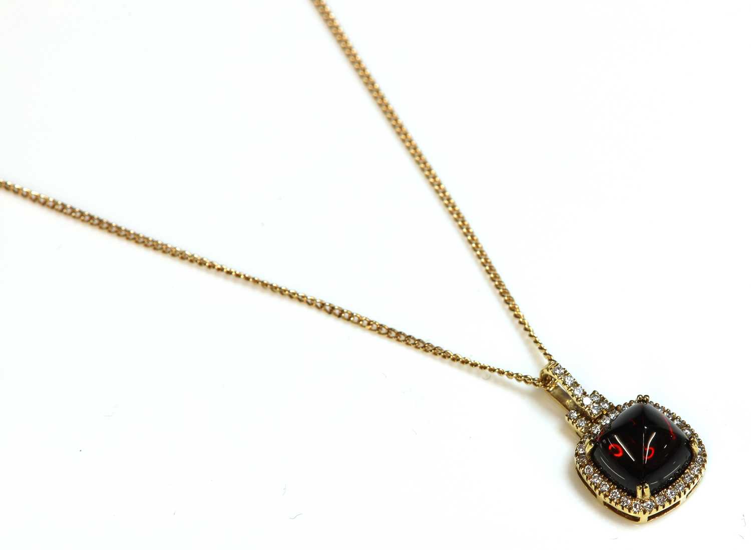 Lot 244 - An 18ct gold garnet and diamond cushion-shaped cluster pendant