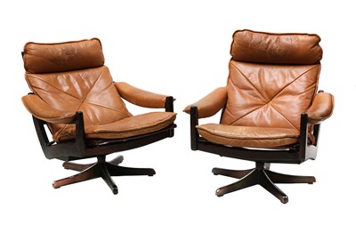 Lot 485 - A pair of tan leather reclining armchairs
