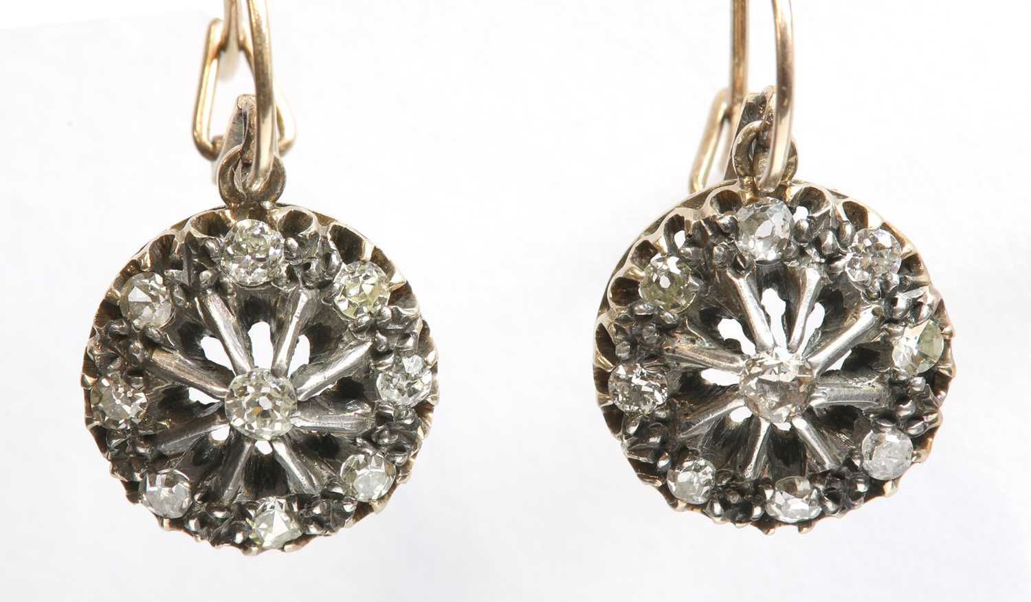 Lot 51 - A pair of Edwardian, diamond set, gold and silver cluster drop earrings, c.1910