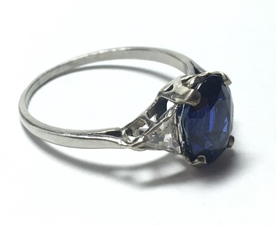 Lot 62 - A platinum sapphire and diamond three stone ring