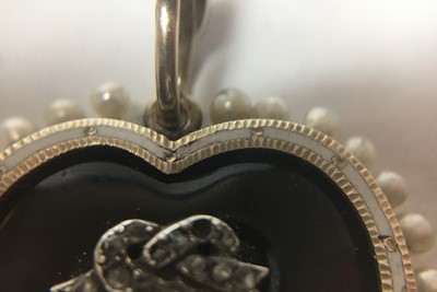 Lot 10 - A Victorian gold onyx, diamond, enamel and seed pearl heart pendant