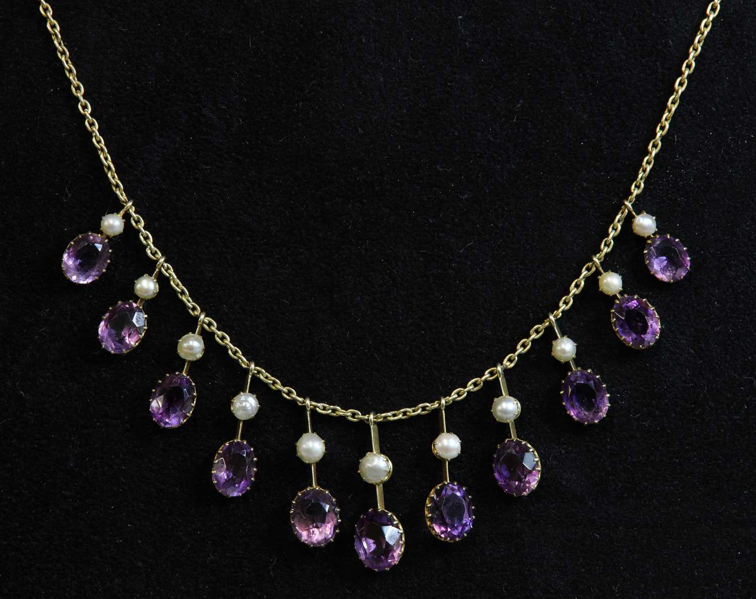Lot 72 - An Edwardian amethyst and split pearl fringe necklace, c.1900