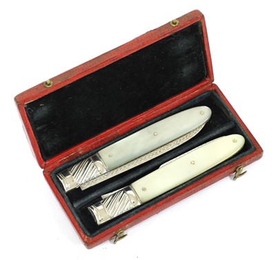 Lot 21 - A mother-of-pearl and silver folding fruit knife and fork set
