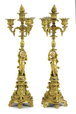 Lot 681 - A pair of Continental ormolu four-light candelabra