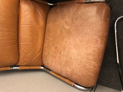 Lot 535 - A tan leather and chrome lounger and stool