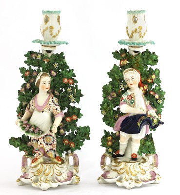 Lot 365 - A pair of Continental porcelain figural candlesticks