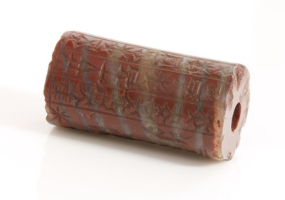 Lot 480 - A Babylonian red banded jasper cylinder seal