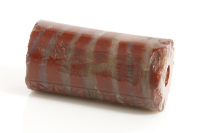 Lot 480 - A Babylonian red banded jasper cylinder seal