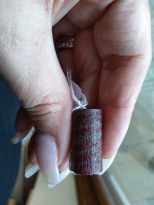 Lot 480 - A Babylonian red banded jasper cylinder seal