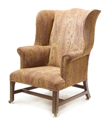 Lot 583 - A George III mahogany wingback armchair