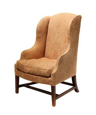 Lot 565 - A George III mahogany wingback armchair