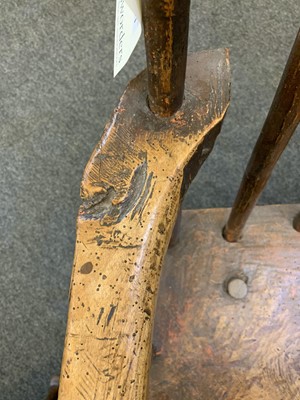 Lot 91 - A primitive fruitwood stick back armchair