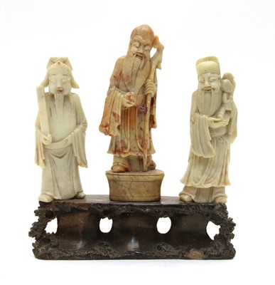 Lot 211 - A Chinese carved soapstone group of three figures
