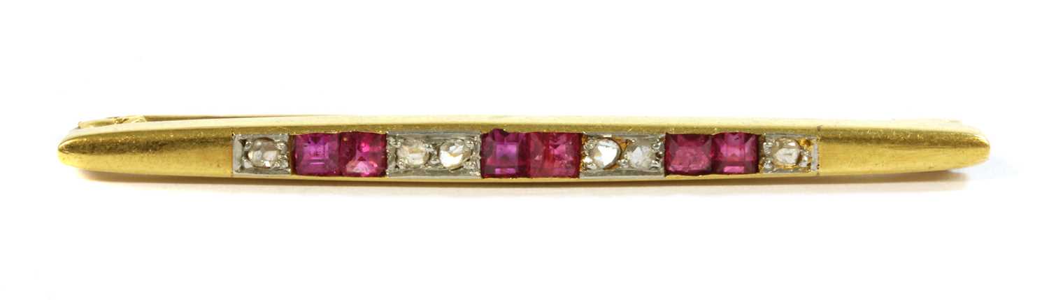 Lot 35 - An Art Deco, gold, ruby and diamond bar brooch
