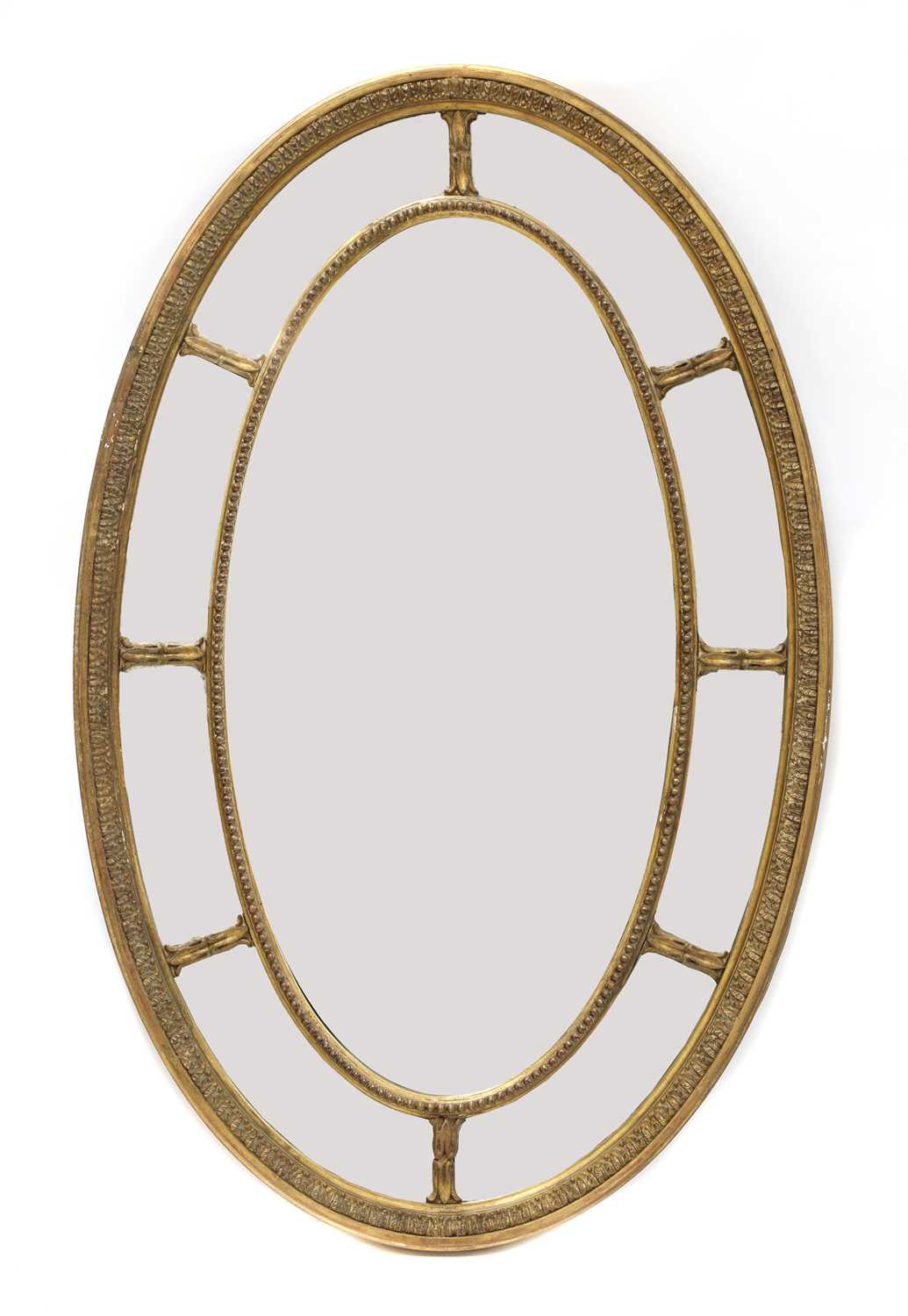 Lot 414 - A carved giltwood and gesso oval wall mirror