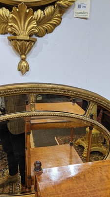Lot 414 - A carved giltwood and gesso oval wall mirror