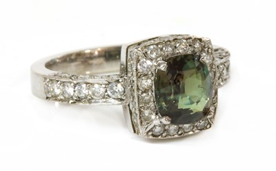 Lot 470 - An 18ct white gold alexandrite and diamond cushion-shaped halo cluster ring