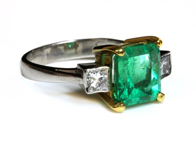 Lot 384 - An 18ct yellow and white gold, three stone emerald and diamond ring