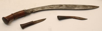 Lot 215 - A Kukri in leather scabbard with two smaller knives