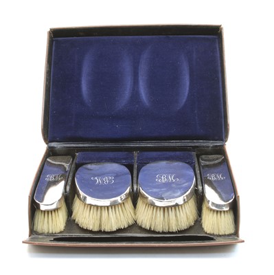 Lot 134 - A leather cased set of four silver backed Gentleman's hair brushes
