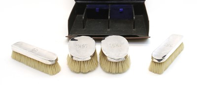 Lot 134 - A leather cased set of four silver backed Gentleman's hair brushes