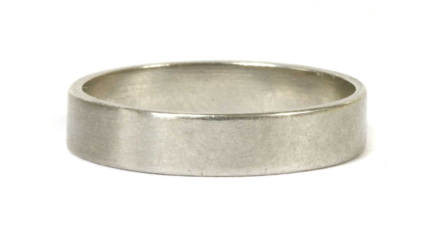 Lot 33 - A platinum flat section wedding ring