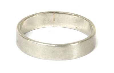 Lot 33 - A platinum flat section wedding ring