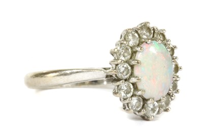Lot 122 - A white gold opal and diamond cluster ring
