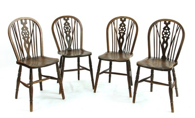 Lot 692 - A set of four wheelback chairs