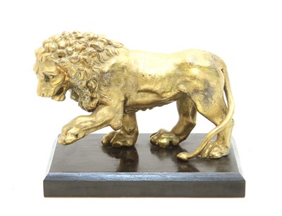 Lot 403 - A gilt metal figure of a Canova Lion, on an ebonised plinth