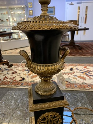 Lot 222 - A pair of Napoleon III ebonised and gilt metal urn form table lamps