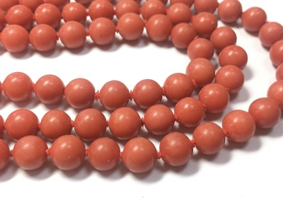 Lot 46 - An Italian gold three row uniform coral bead necklace