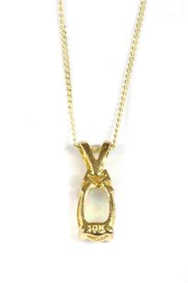 Lot 124 - A gold opal and diamond pendant