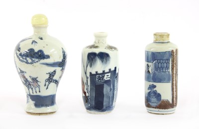 Lot 253 - Three Chinese underglaze blue and copper-red porcelain snuff bottles